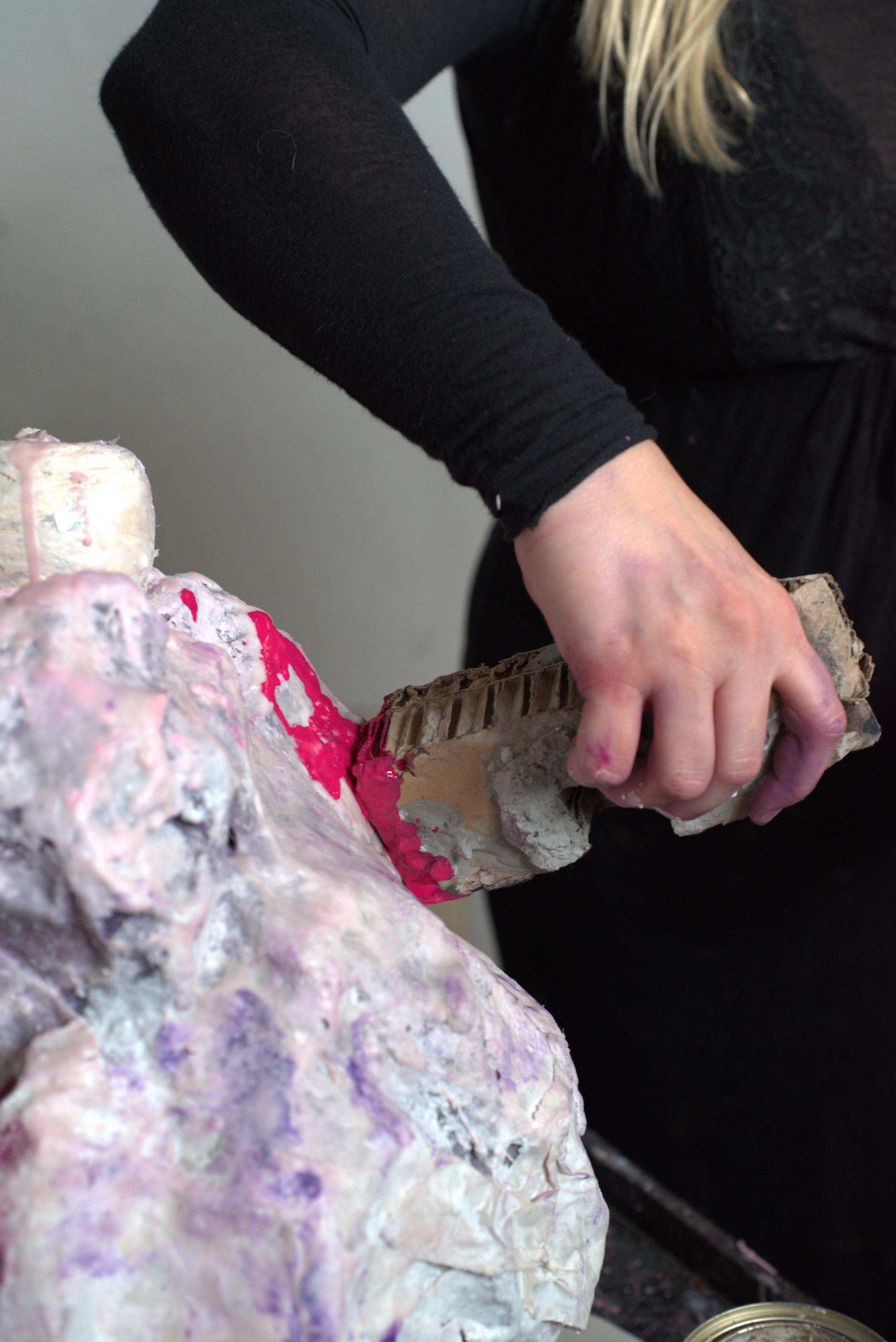 Image of a person sculpting with encaustic paint 